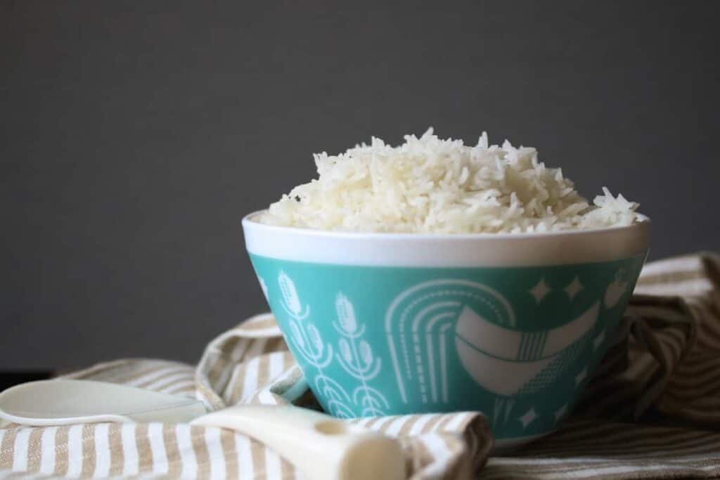 White rice in a pyrex bowl on a striped towel