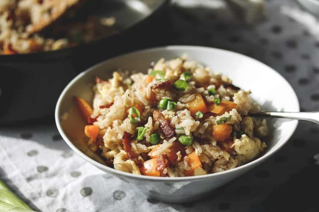 a white bowl with bacon fried rice