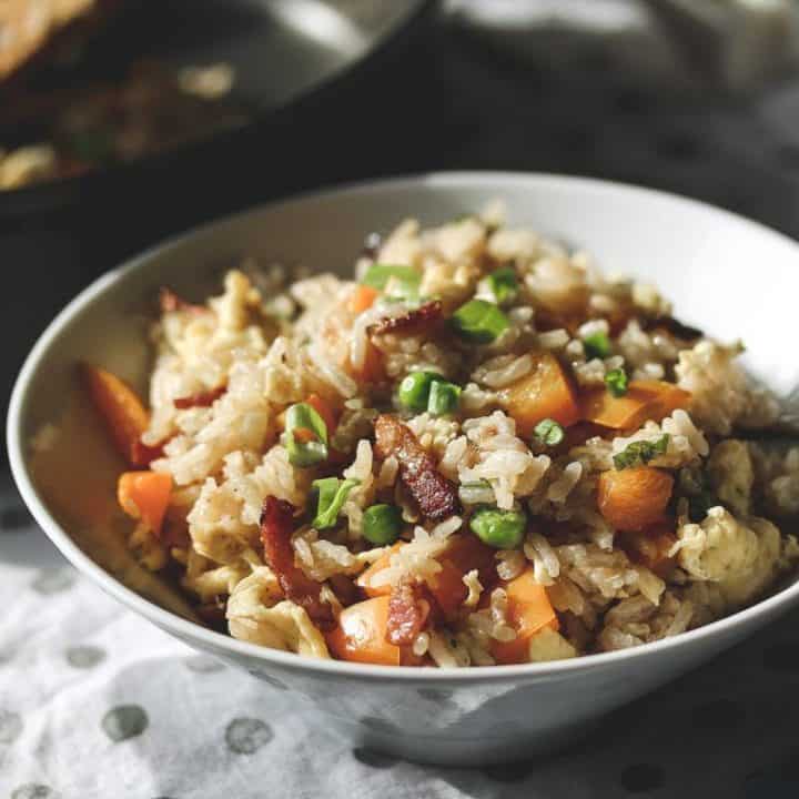 a white bowl with bacon fried rice