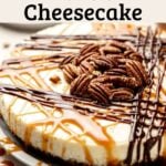 Gluten-free turtle cheesecake topped with caramel, chocolate drizzle, and pecans on a light plate.