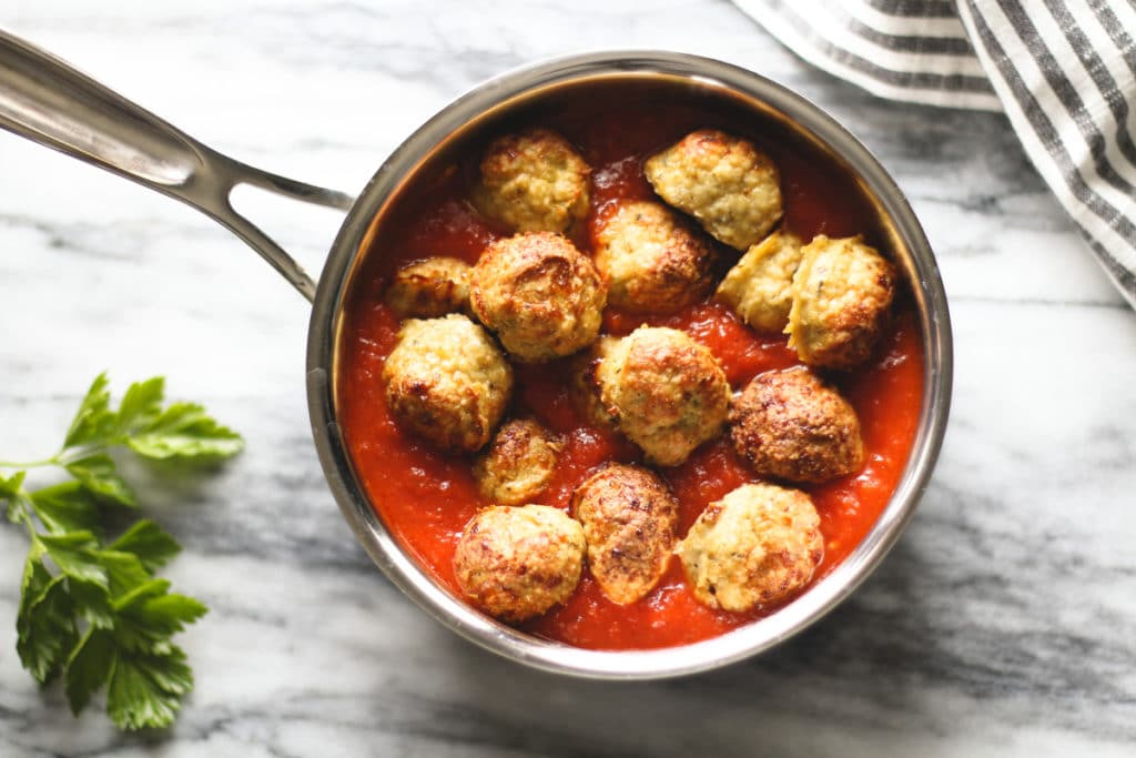 Baked Chicken Meatballs in a saucepan with red sauce