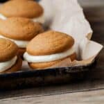 Gluten-Free Pumpkin Whoopie Pie with white frosting filling.