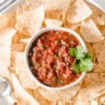 chipotle restaurant style salsa in a bowl surrounded by chips.