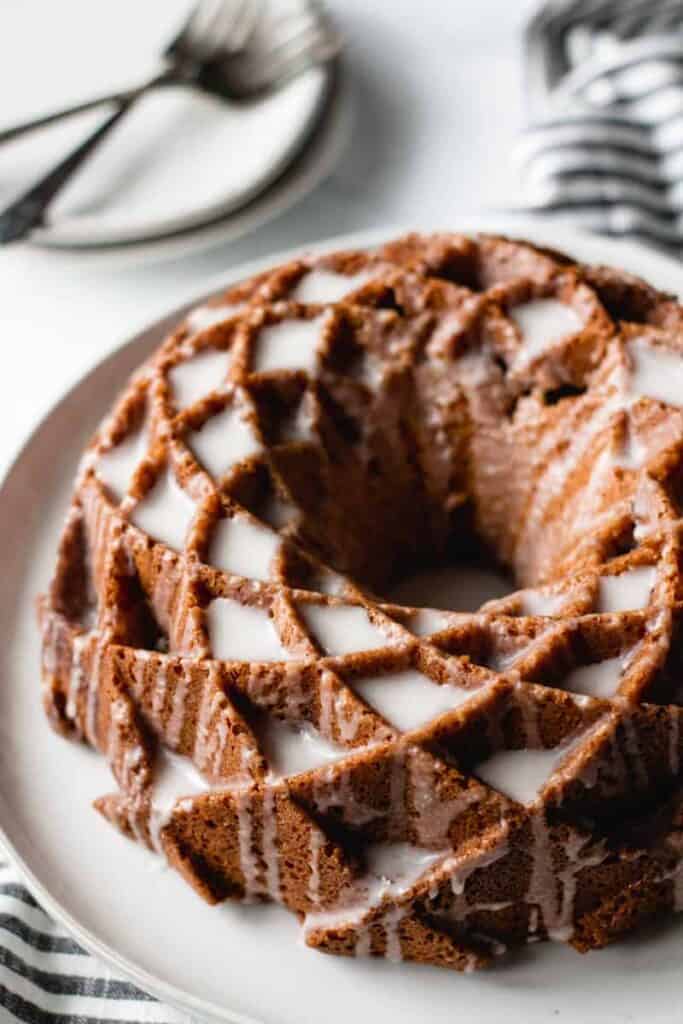 sour cream coffee cake, bundt cake on a plate, icing dripping down sides