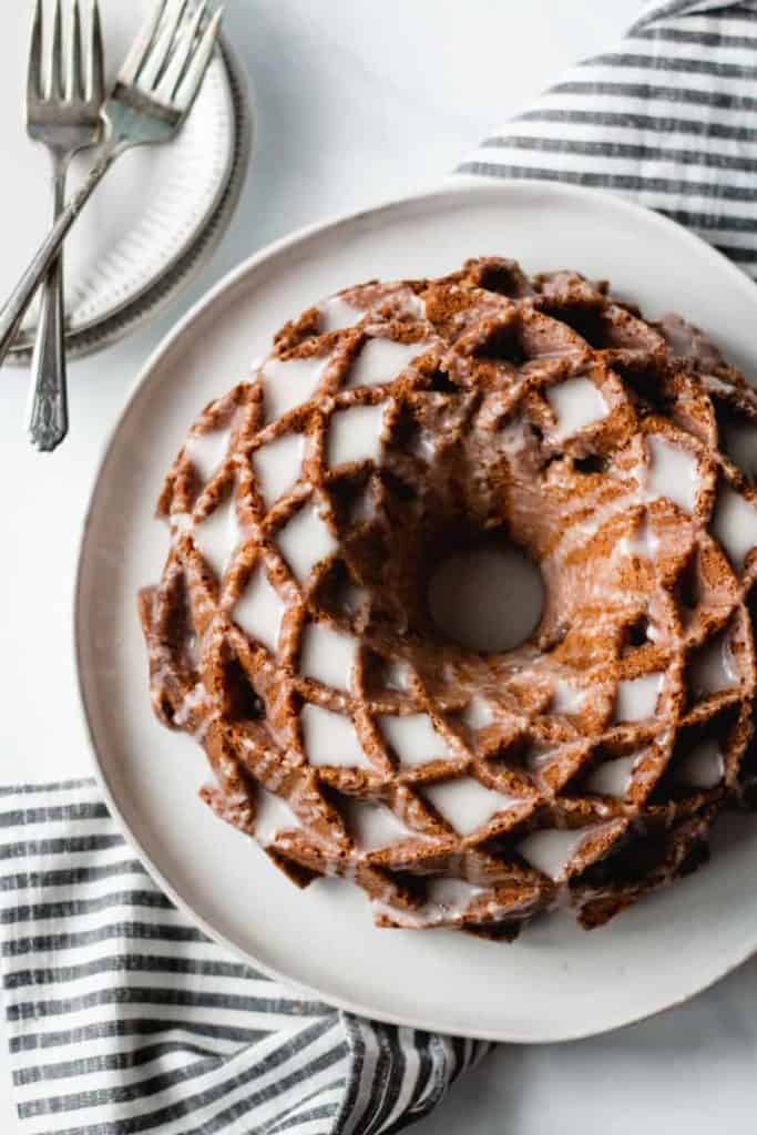 sour cream coffee cake, bundt cake on a plate, icing dripping down sides