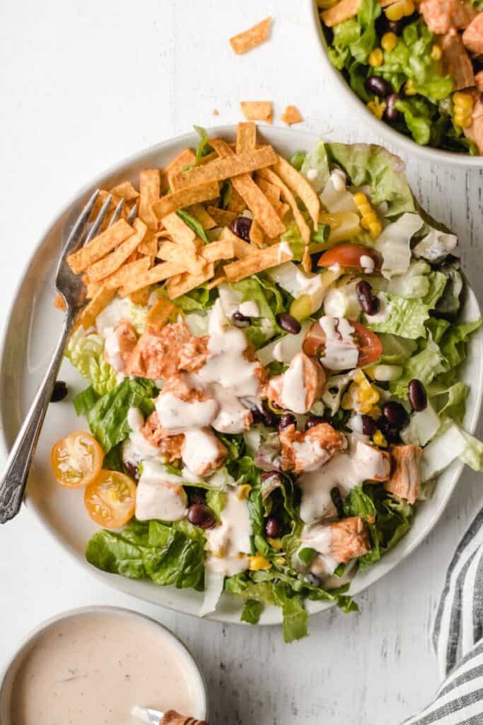 southwest bbq chicken salad with chipotle ranch dressing on top.