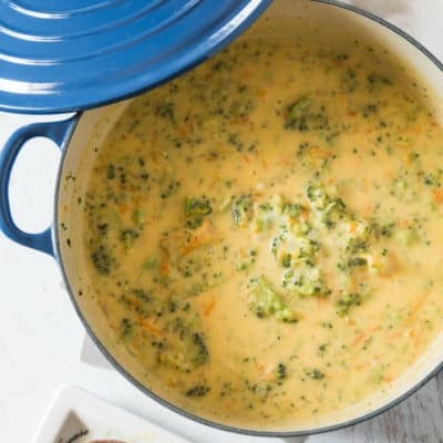 A big blue pot filled with broccoli cheddar soup.