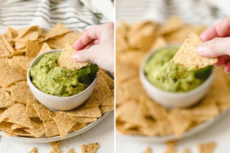 Guacamole being dipped into with a chip.