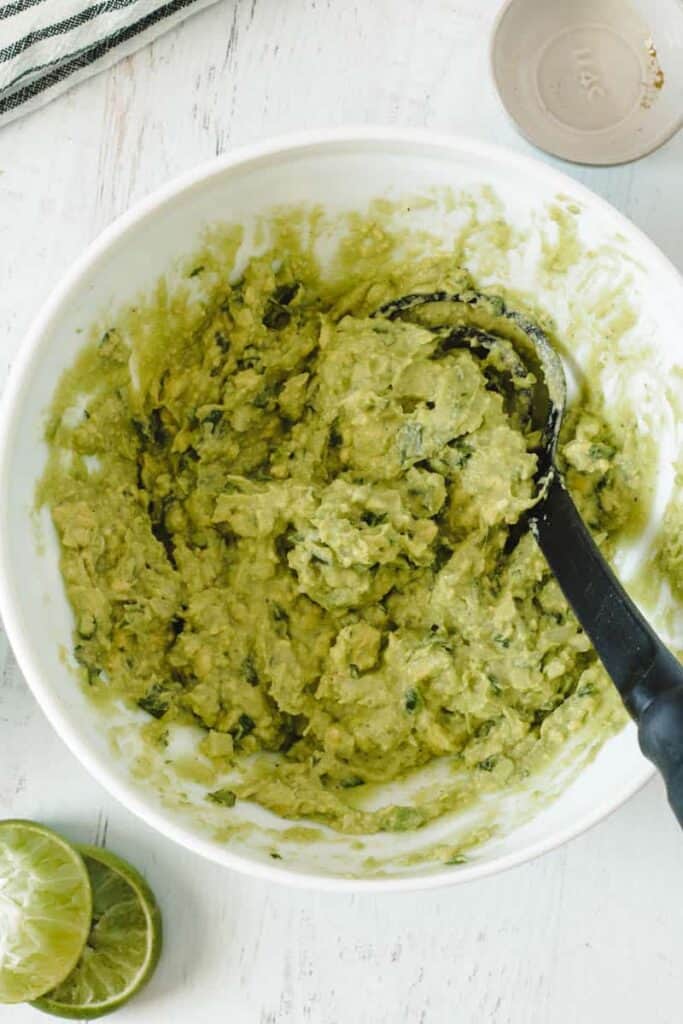 Guacamole in a bowl with the mix 'n masher.