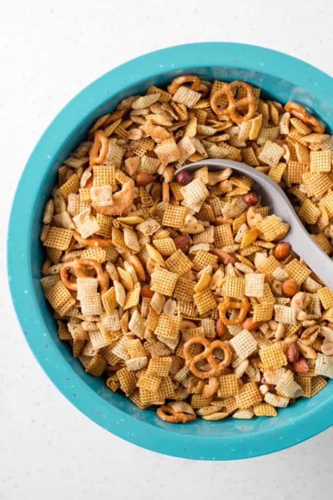 Chex mix in a large turquoise confetti bowl by Zak designs.