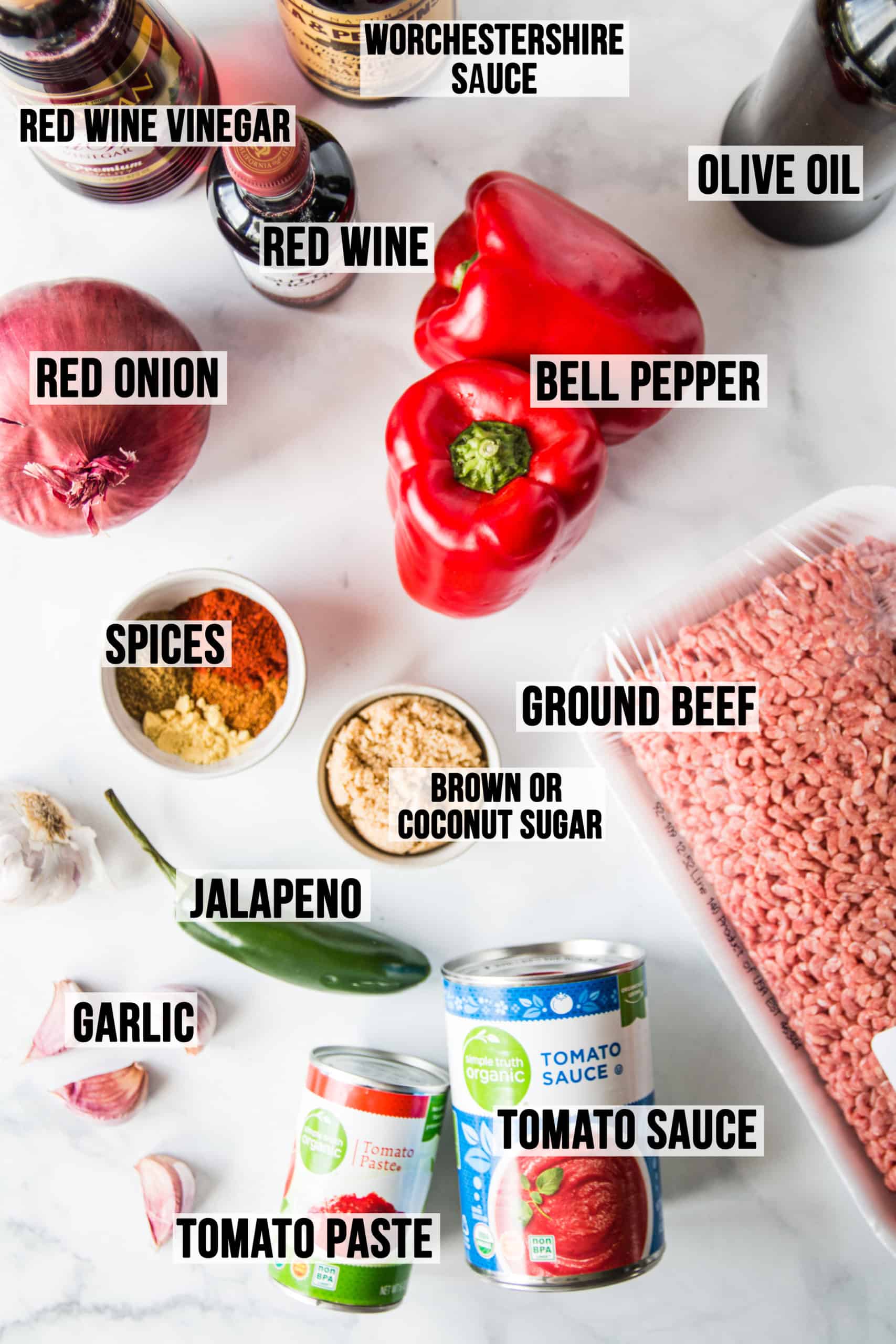 Ingredients in gluten free sloppy joes laid out on white surface.