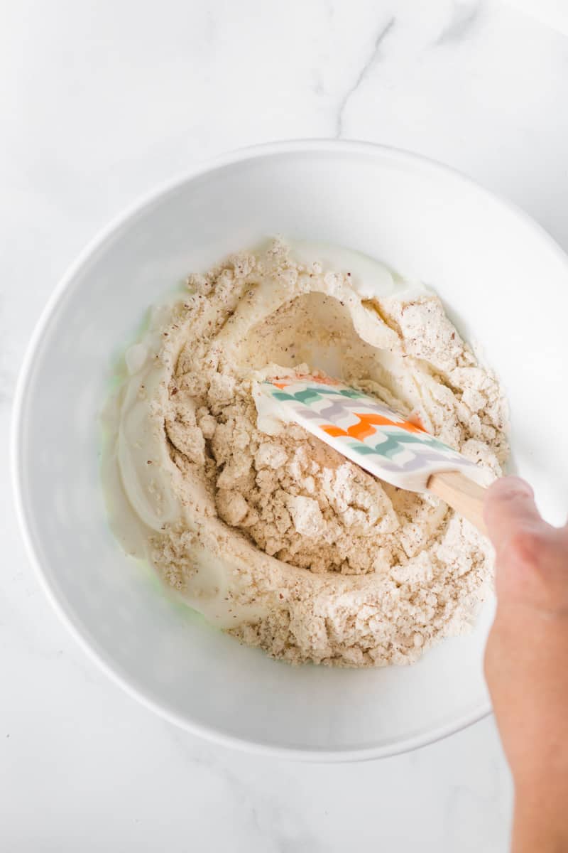 Mixing greek yogurt and baking mix.