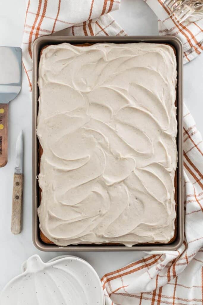 The entire pan of pumpkin bars with frosting swirls on top.