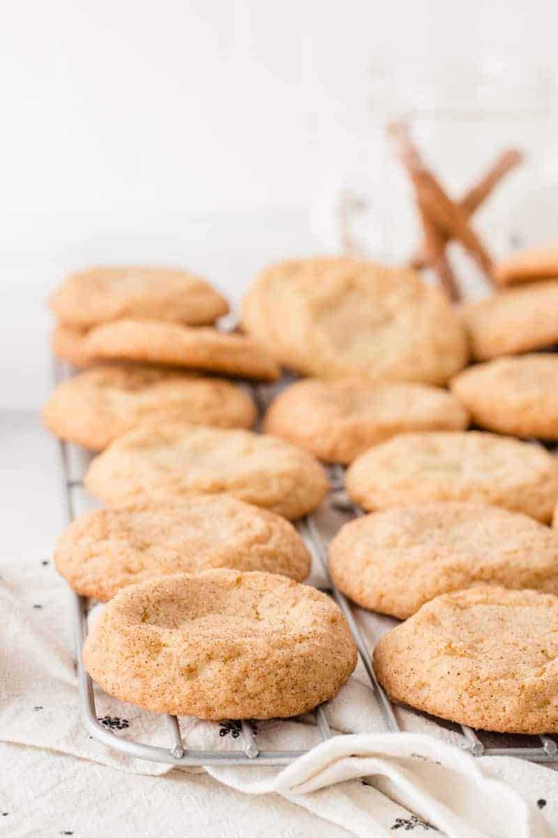 A wire cooling rack full of gluten-free snickerdoodle cookies.