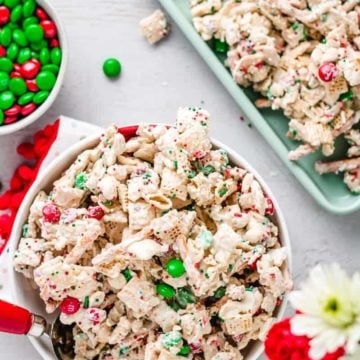 Christmas Chex min in a bowl and on mint green cookie sheet.