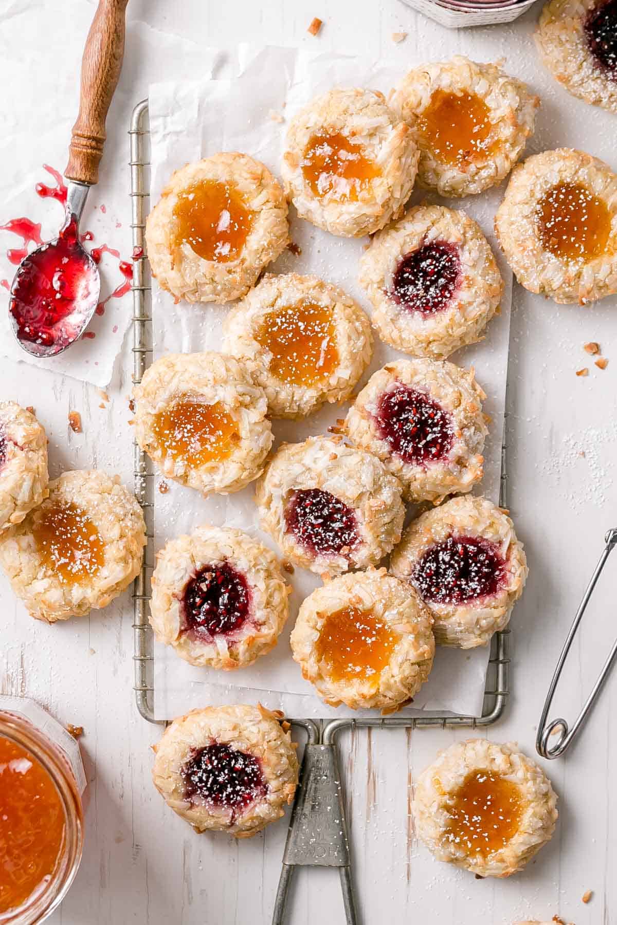 Overhead view of jam filled thumbprints on wooden surface.