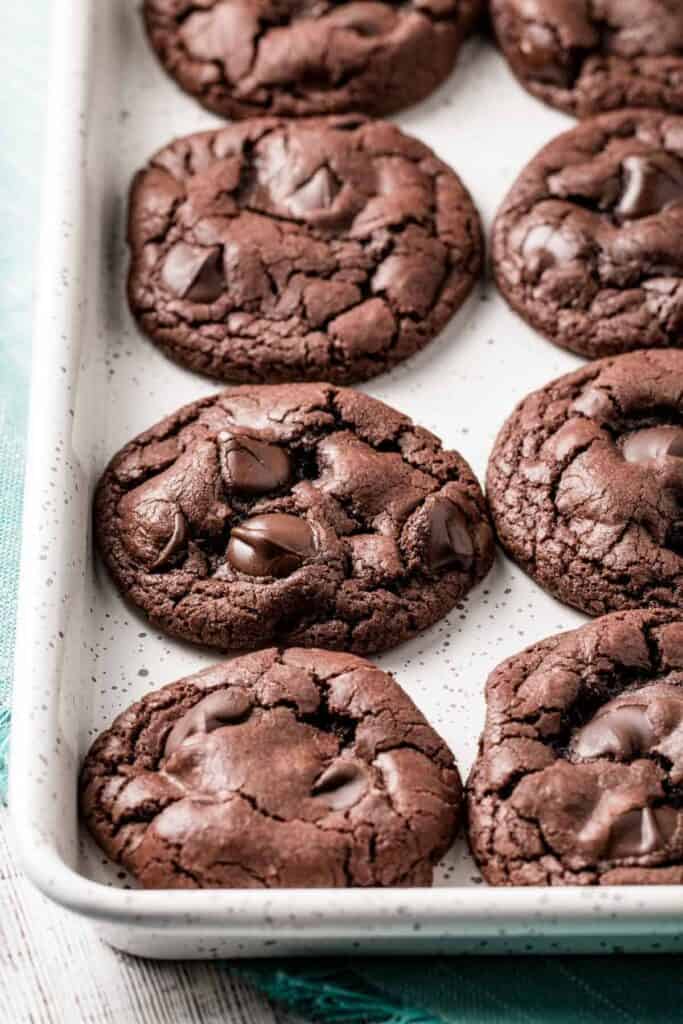 A speckled baking pan filled with GF double chocolate chip cookies.