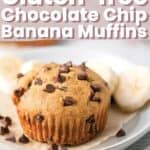 A muffin on a plate with banana slices and chocolate chips.