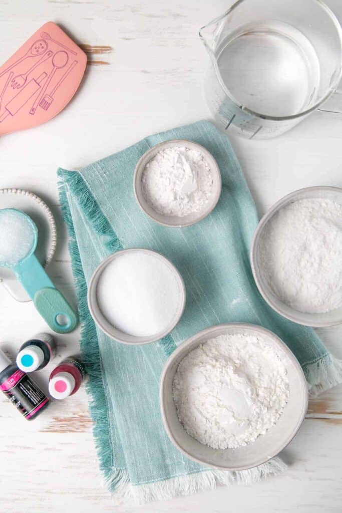 Corn starch, rice flour, and other gluten-free play dough ingredients measured out in bowls.