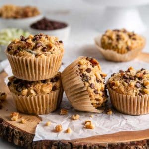 Gluten-free zucchini muffins lined up and two are stacked.