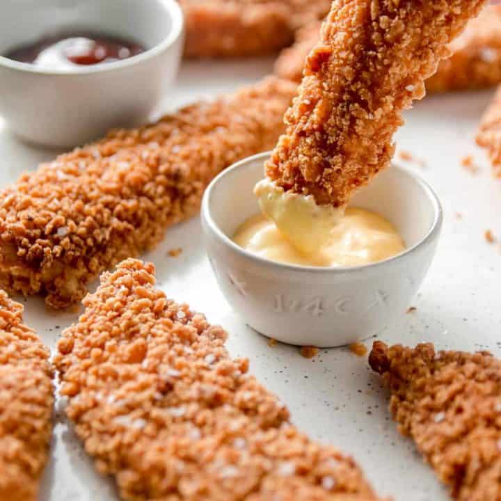 Crispy gluten-free chicken tender dunked into honey mustard sauce.