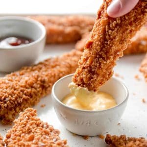 Gluten-free Chicken Tenders dunked in honey mustard.