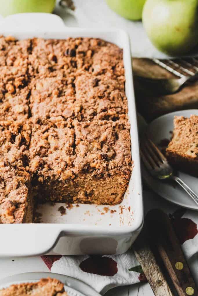 Gluten-free Apple Crumb Coffee cake cut into squares in a baking dish.