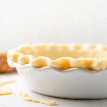 Gluten-free pie dough in white pie plate.