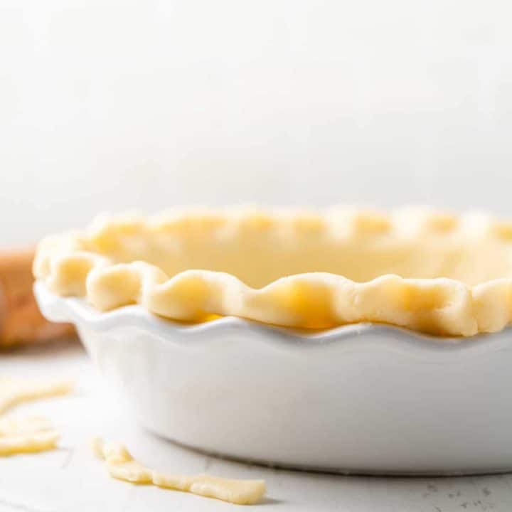 Gluten-free pie dough in white pie plate.