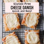 Six gluten-free cheese danish with lines of frosting on a black cooling rack.