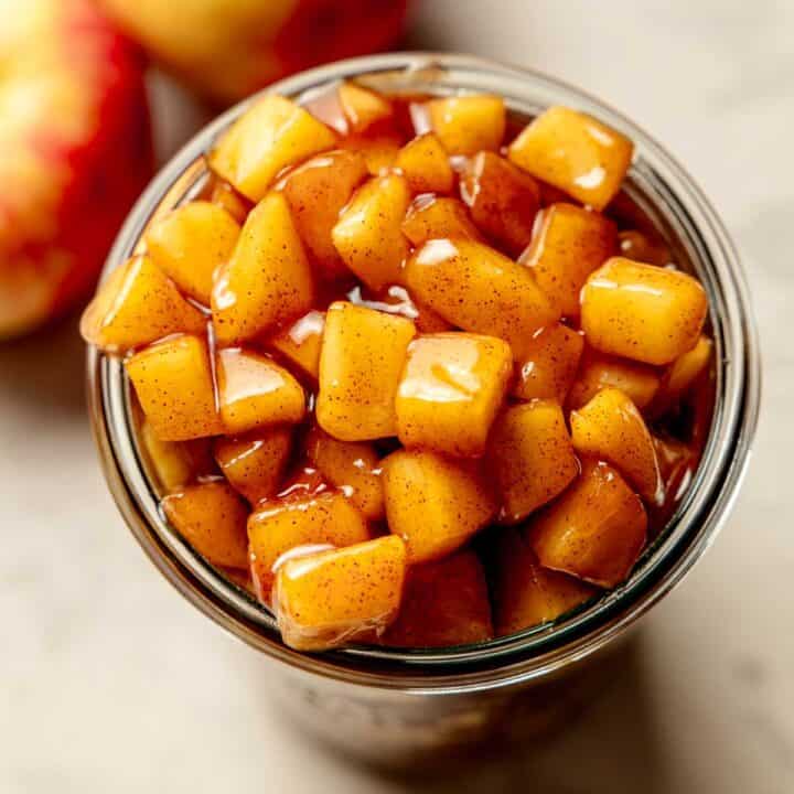 A weck jar filled to the brim with precooked apple pie filling.
