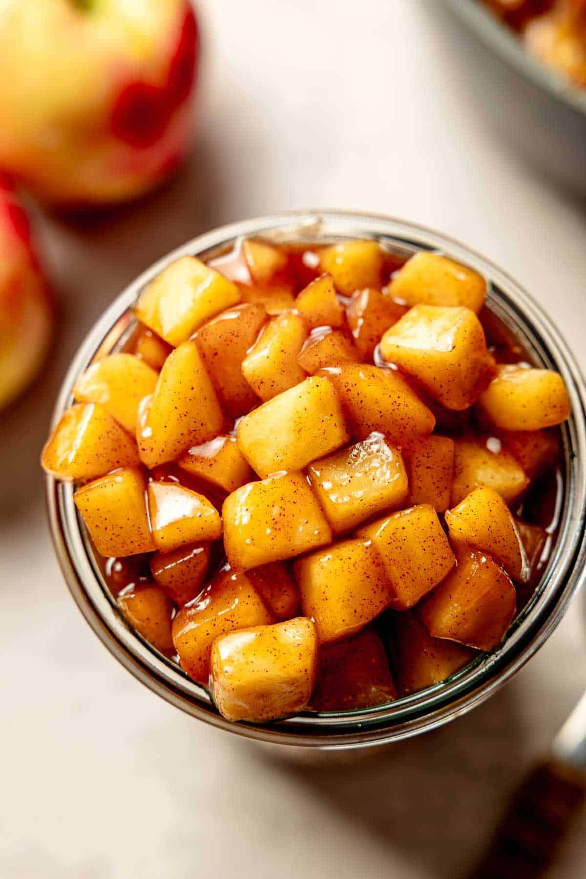 A weck jar filled to the brim with precooked apple pie filling.