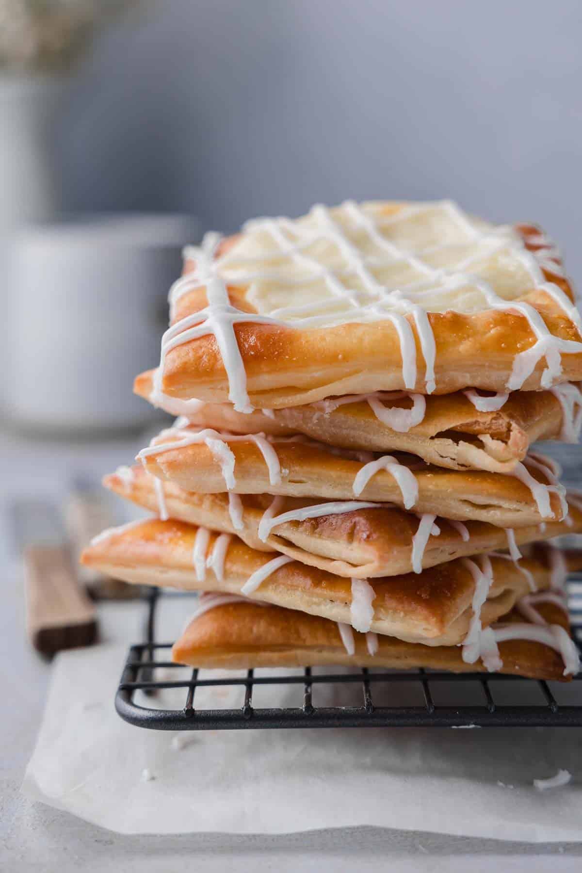 A stack of gluten-free cheese danish on a wire rack.