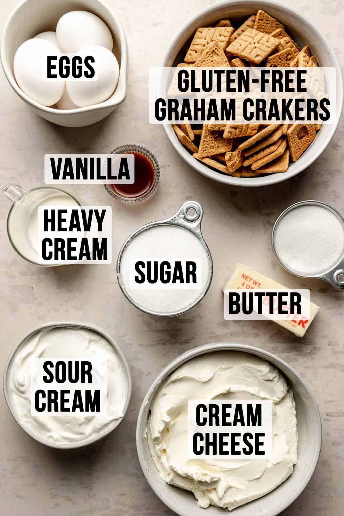 Ingredients needed to make gluten free cheesecake measured out in bowls.