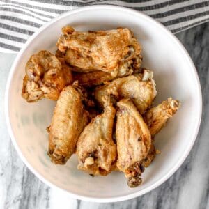 Crispy gluten free chicken wings in bowl.