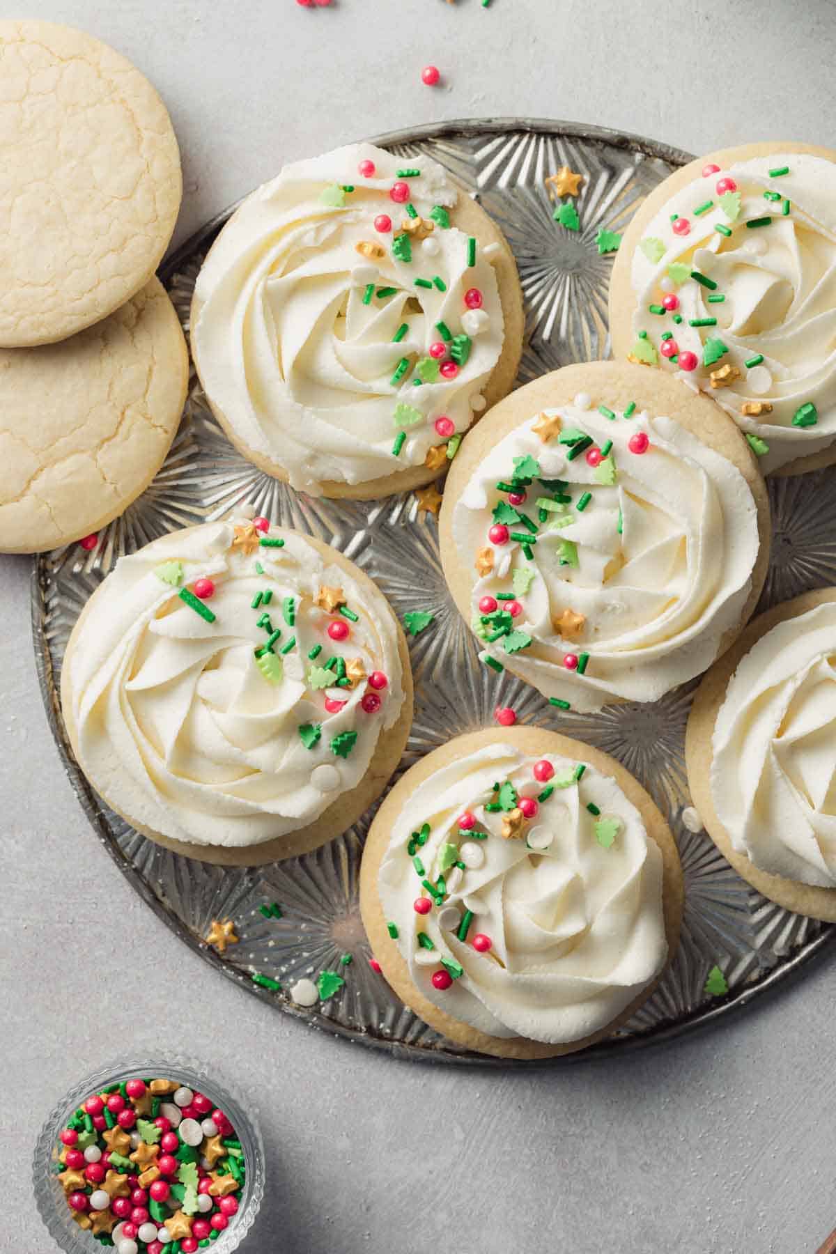 Frosted gluten free sugar cookies on a silver tray.