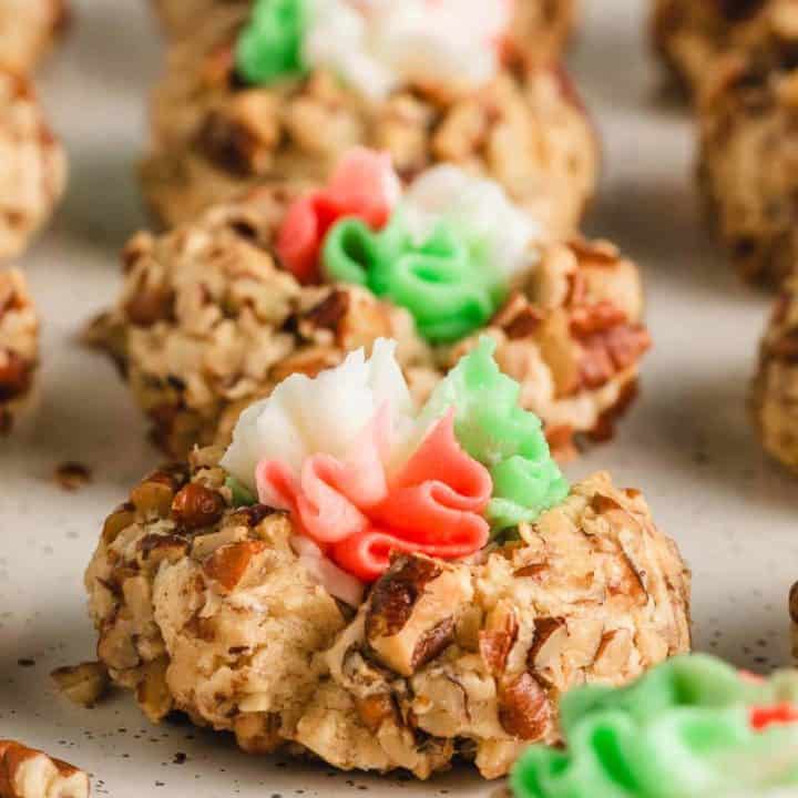 A row of thumbprints with red, white, and green buttercream icing.