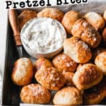 Gluten-free soft pretzel bites made with three ingredient dough in a small pan next to cream cheese.