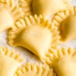 Gluten-free ravioli that are half circles with crimped edges.
