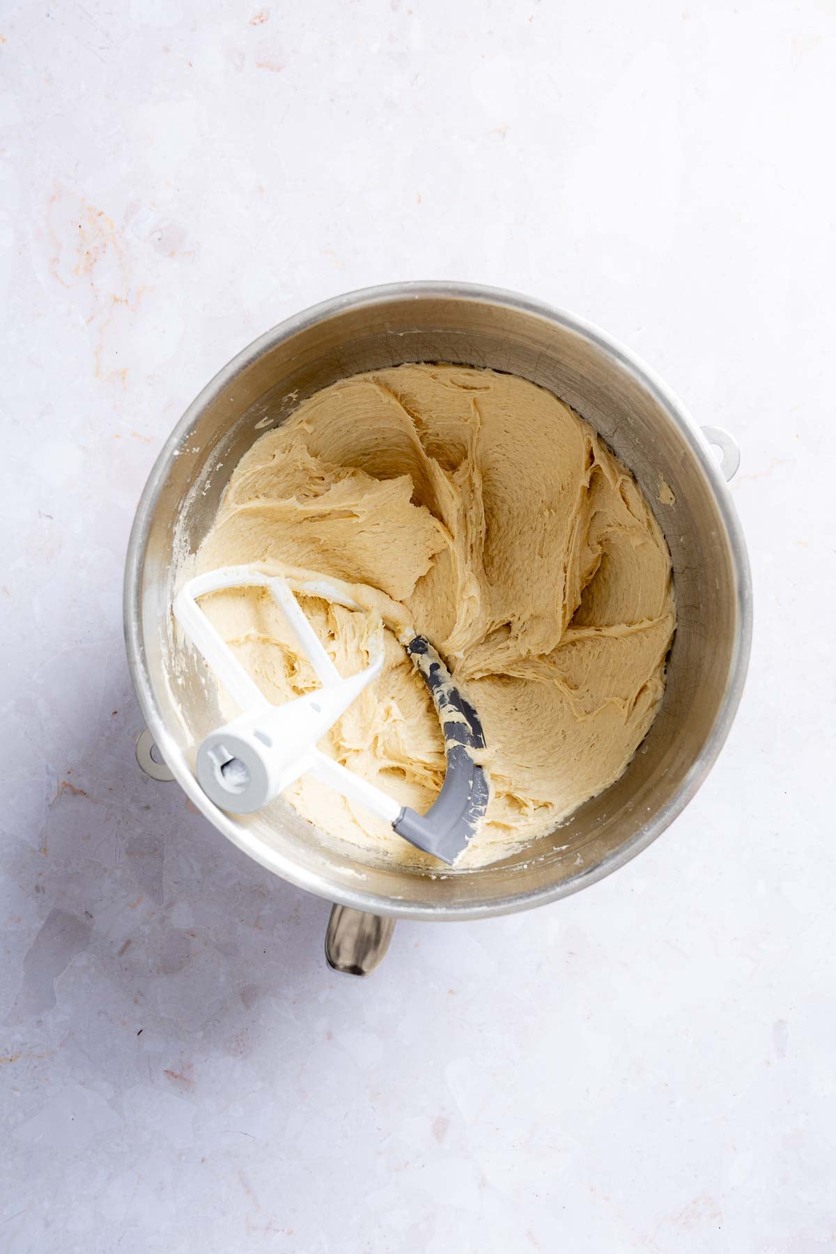 Dough blended in stand mixer bowl, showing thick batter texture.