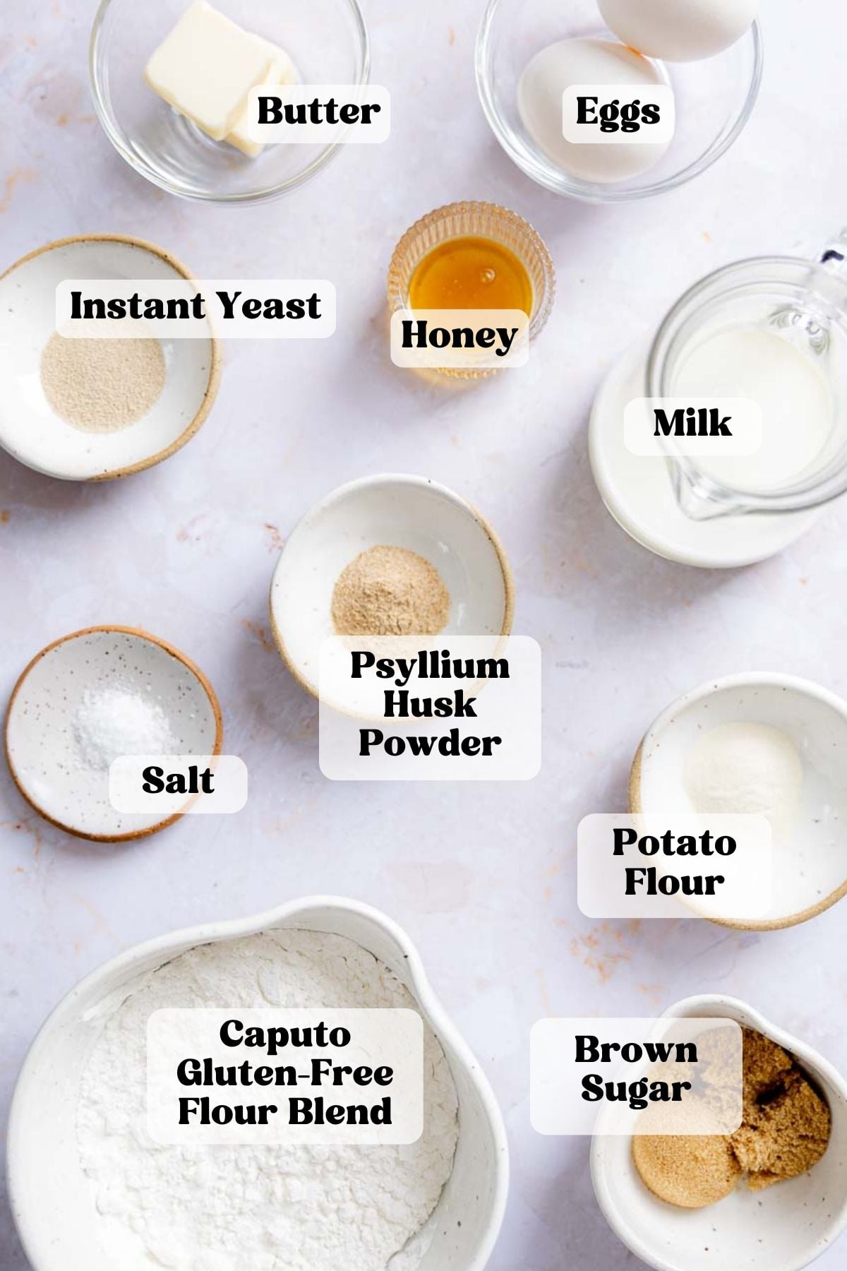 Ingredients for gluten-free hawaiian rolls measured out in bowls.