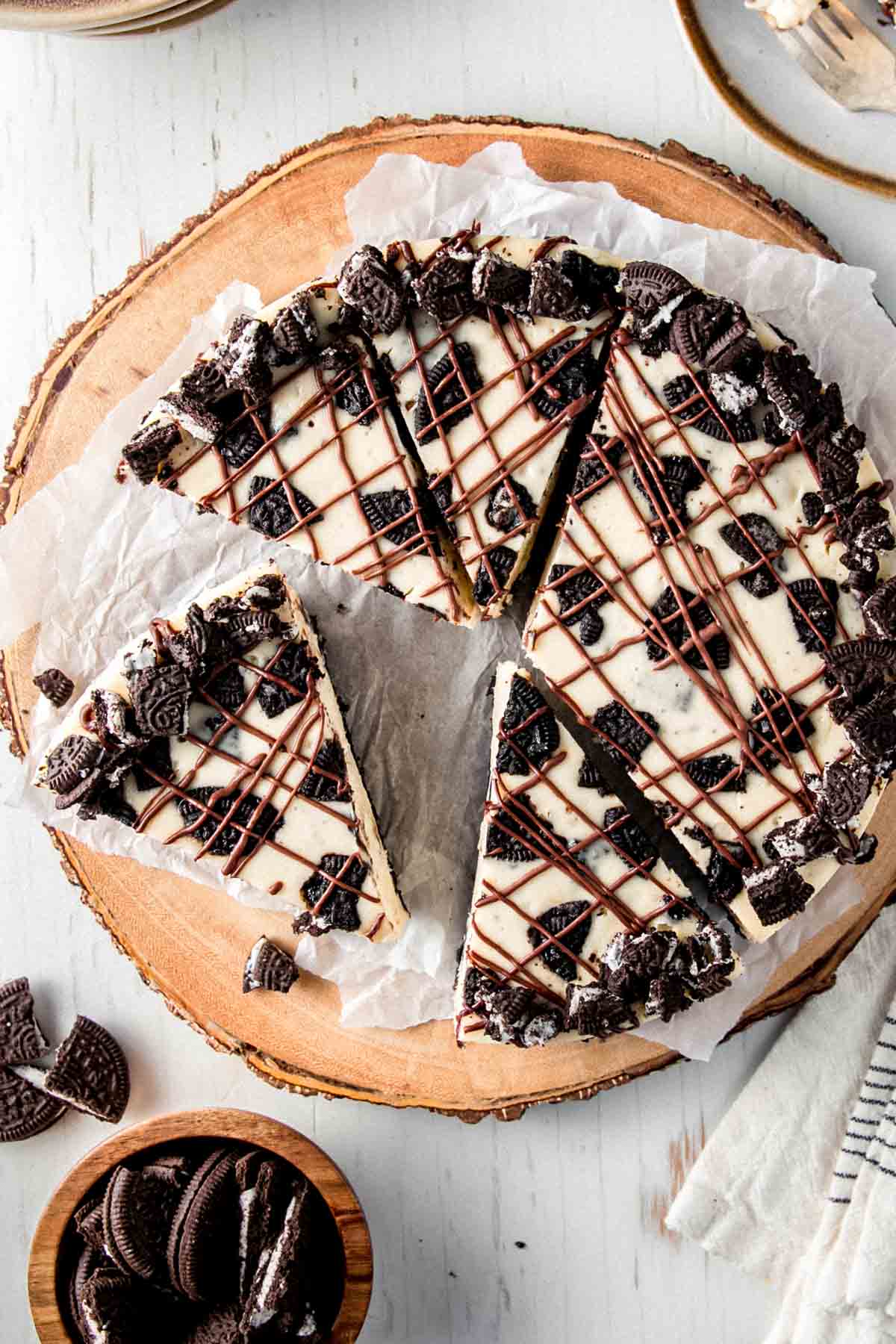 Overhead view of Oreo cheesecake showing the chocolate drizzle and Oreo pieces. 