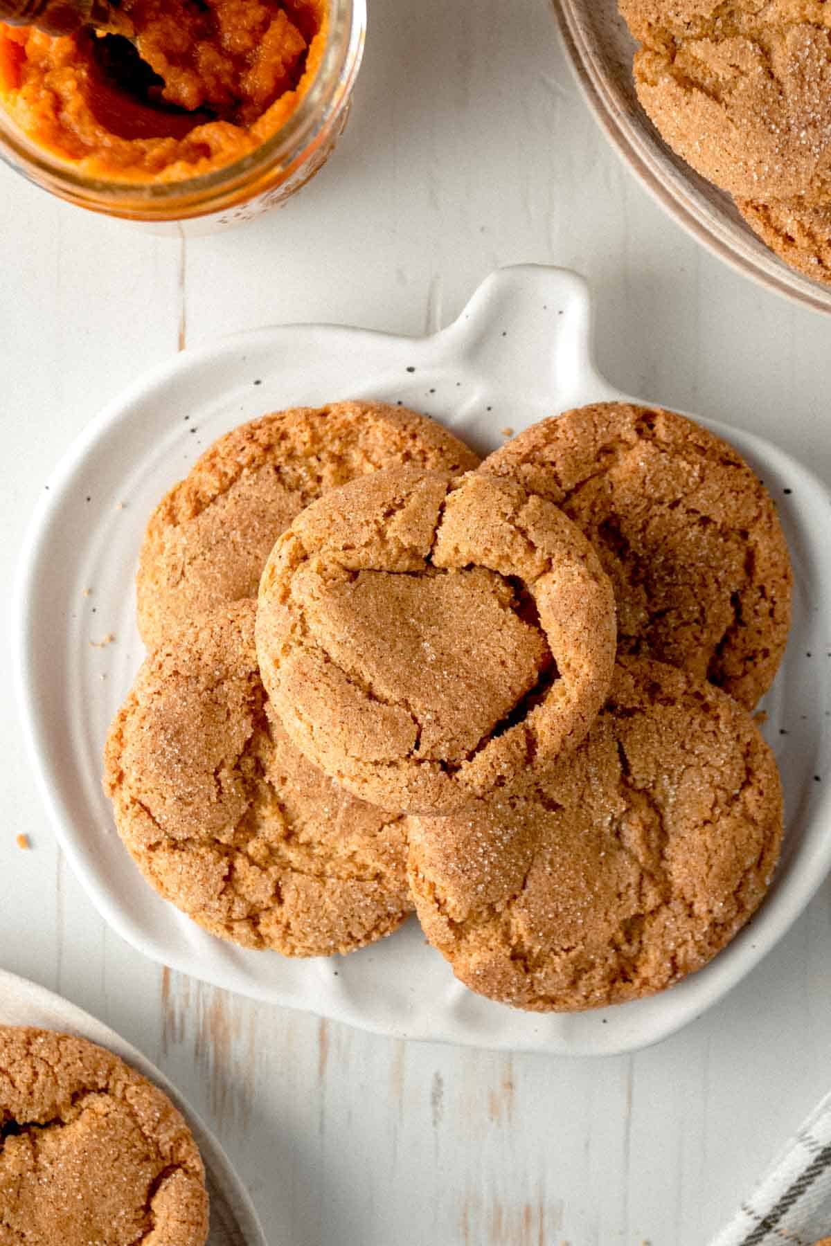 Gluten-free pumpkin snickerdoodle cookies on a pumpkin shaped plate.