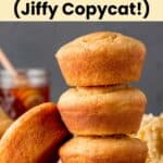 Three gluten free corn muffins stacked on top of each other, one resting to the side.