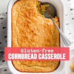 Gluten free corn casserole in white dish with scoop removed.