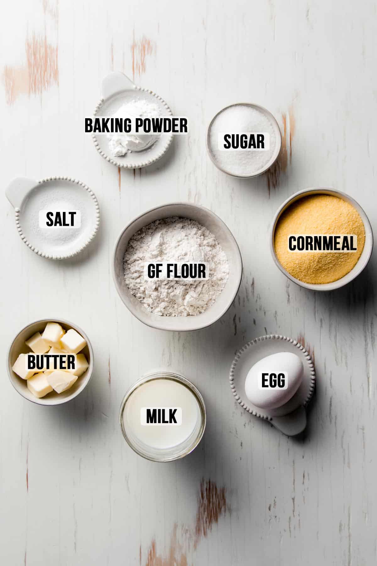 Ingredients for gluten-free jiffy cornbread measured out in bowls.
