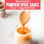 Pumpkin spice sauce drizzling from a spoon into a mason jar.