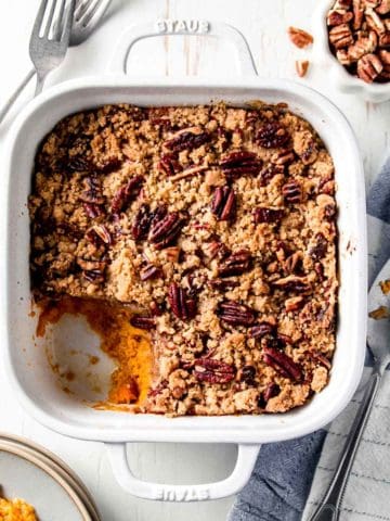 Gluten free sweet potato casserole in white dish with scoop removed.