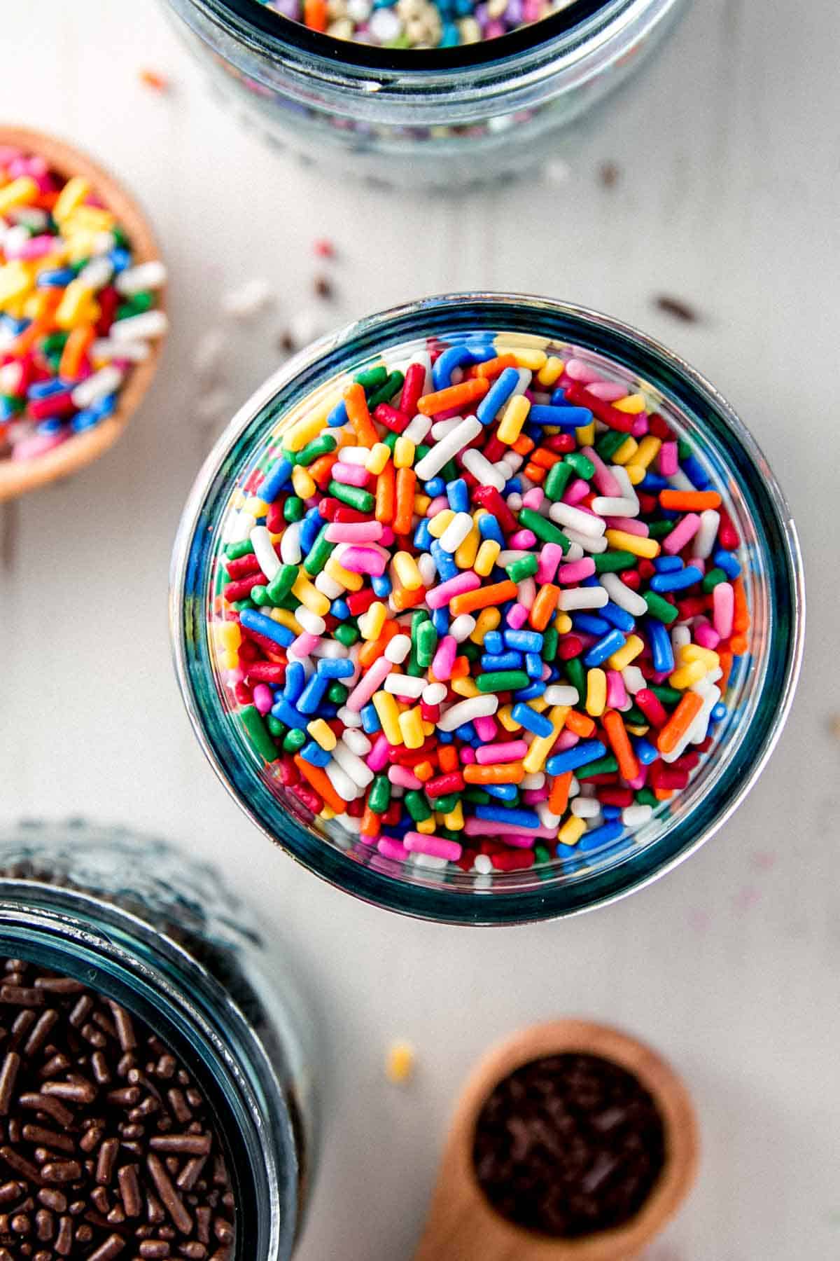 Overhead view of jar filled with rainbow sprinkles.