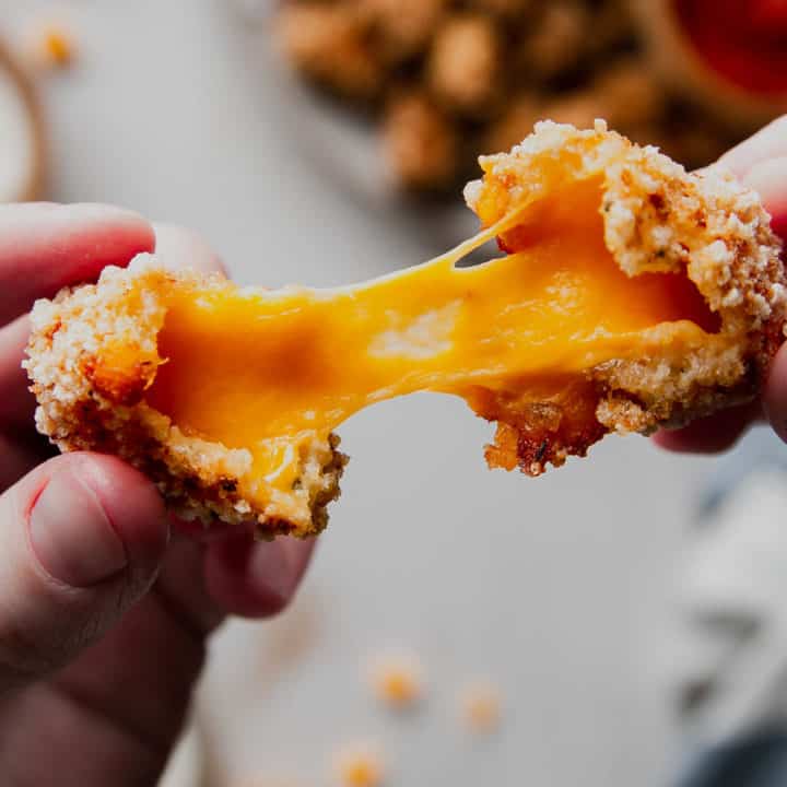Melty cheese pull of broken open cheese curd.